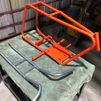 Orange powder coated metal frame project in the workshop