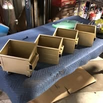 Tan powder coated metal enclosures lined up on a table