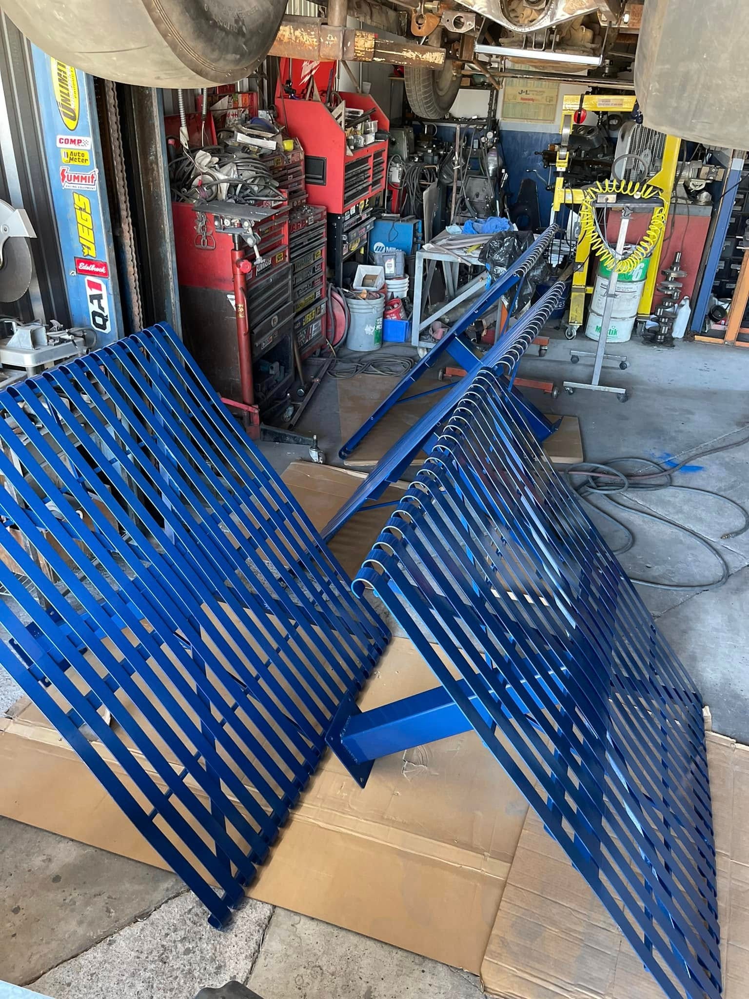 Blue powder coated metal ramps in the workshop